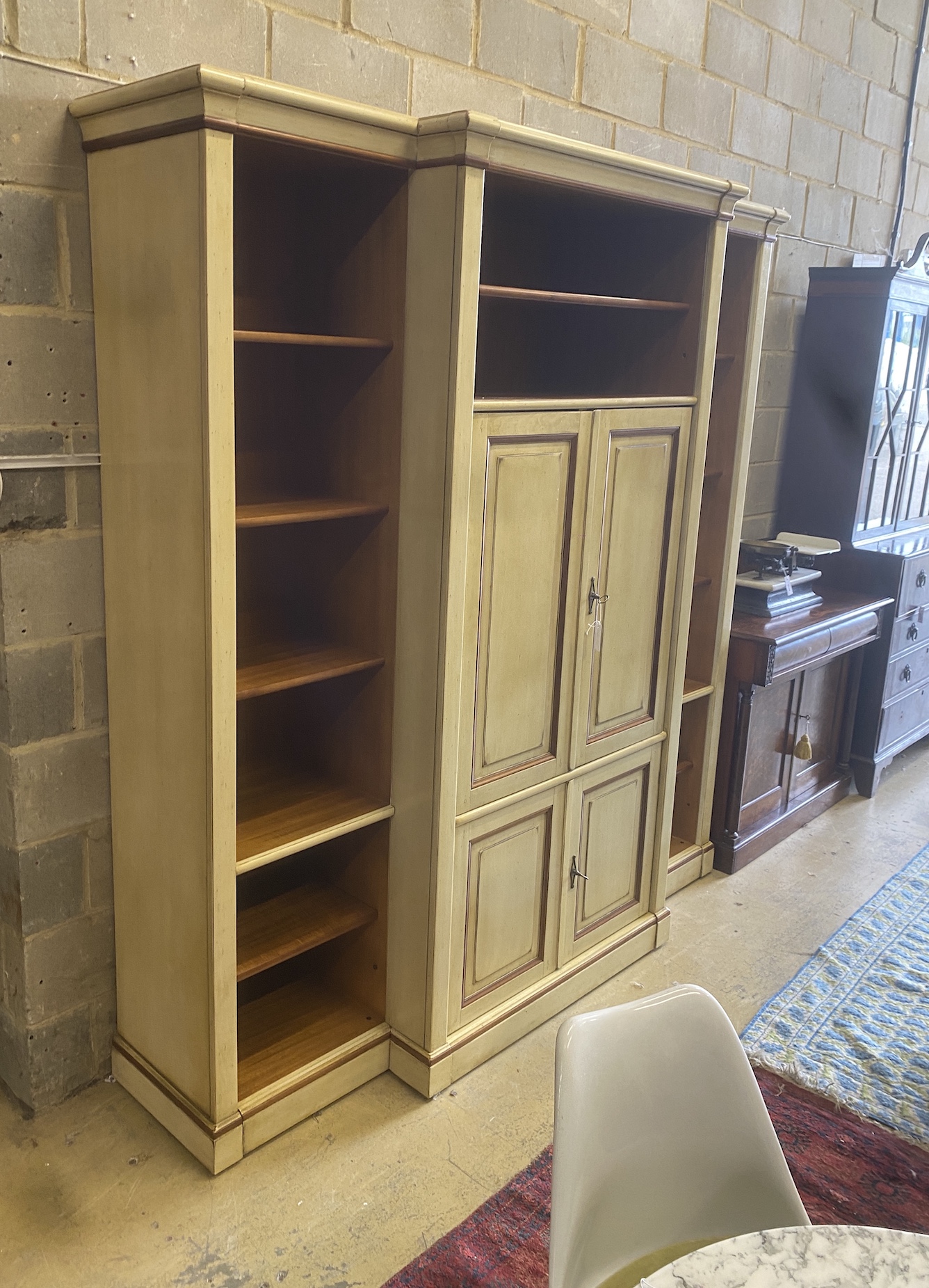A reproduction Continental painted breakfront bookcase / media cabinet, width 204cm, depth 55cm, height 222cm